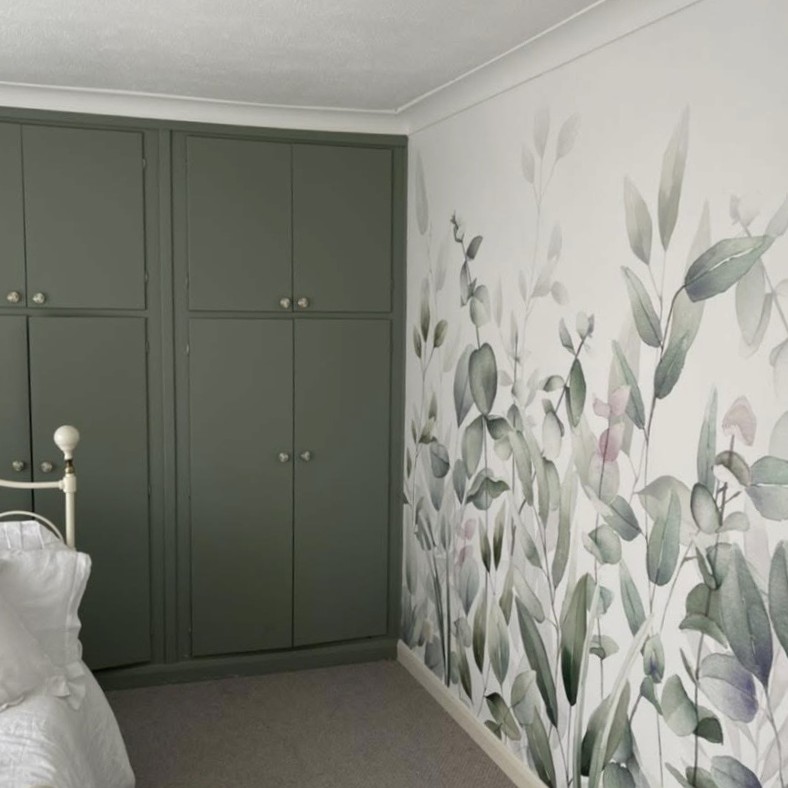 Sage green wardrobe next to finished green floral feature wall